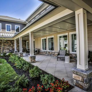 A spacious patio with outdoor seating and a well-maintained garden.