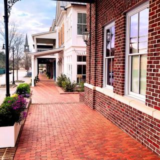 A picturesque brick sidewalk lined with classic architecture and windows.