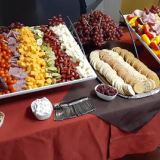 A vibrant spread of fruits, cheeses, and cookies arranged elegantly for a gathering.