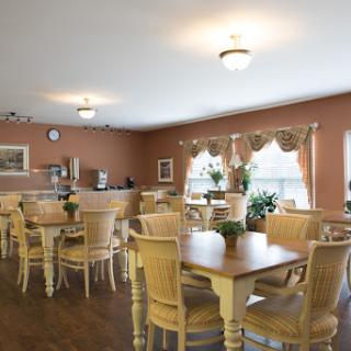 A cozy dining area featuring wooden furniture and natural light.