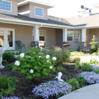 A well-maintained garden in front of a residential house.