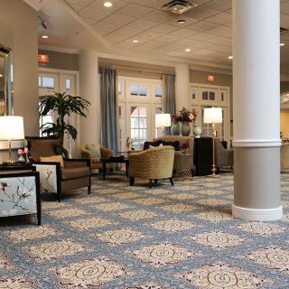 A hotel lobby featuring elegant decor, comfortable seating, and warm lighting.