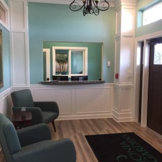 A cozy and stylish waiting room with comfortable chairs and elegant decor.