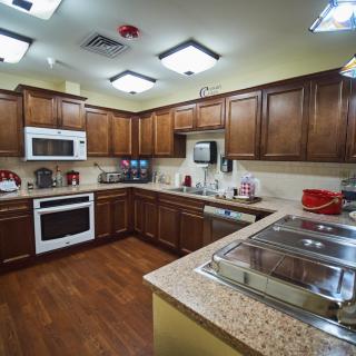 A well-equipped kitchen with wooden cabinets and modern appliances.