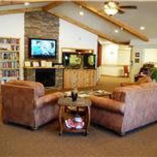 A cozy living room with comfortable couches, a television, and a fireplace.