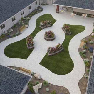 An aerial view of a landscaped courtyard with green lawns and curving pathways.