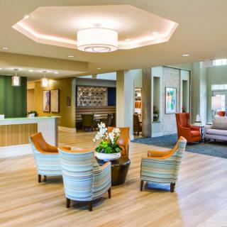A modern lobby with comfortable seating and a reception desk.