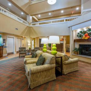 A spacious hotel lobby with comfortable seating and warm lighting.