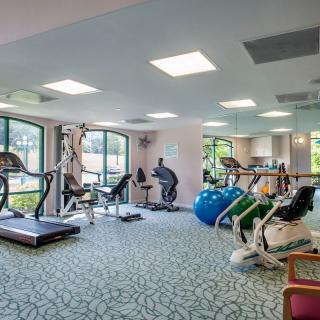A well-equipped gym with various exercise machines and fitness equipment.