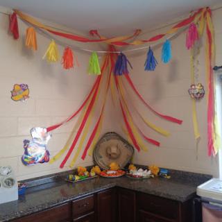 A vibrant corner of the kitchen adorned with colorful tassel decorations, perfect for a festive atmosphere.