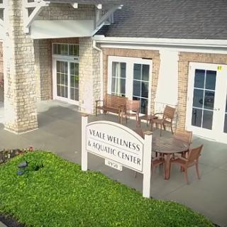 A welcoming view of a community center featuring outdoor seating and a friendly entrance.