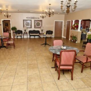 A spacious lobby area with elegant seating and chandeliers.
