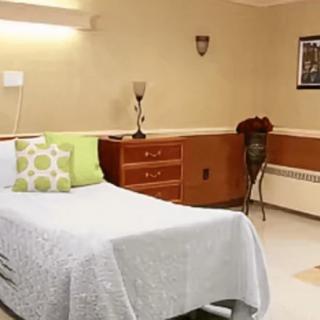 A clean and neatly arranged hospital room with a single bed.