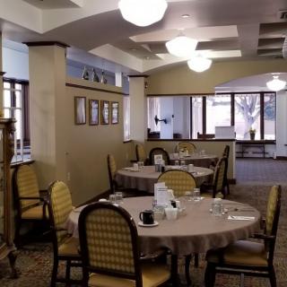 A cozy dining area with neatly arranged tables and chairs.