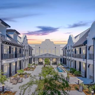 A beautifully designed residential courtyard at sunset, showcasing modern architecture.