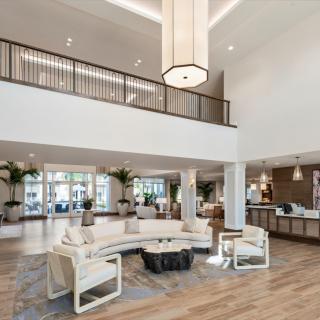 A spacious, modern lobby featuring elegant lighting and comfortable seating arrangements.