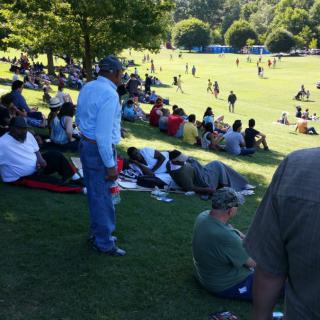 People relaxing and enjoying a sunny day in the park.