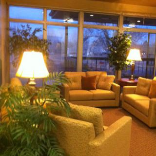 A cozy living room area with comfortable couches and warm lighting.