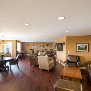 A spacious living room with comfortable seating and hardwood floors.