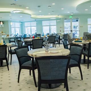 A modern dining area with neatly arranged tables and chairs, ready for guests.