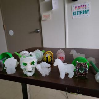 A variety of colorful plastic decorations displayed on a table for a birthday celebration.