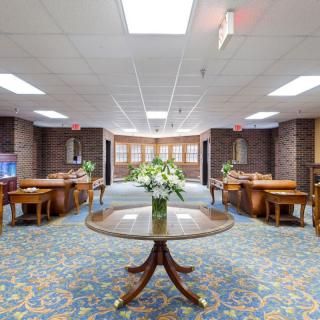 A spacious lobby area with floral arrangements and elegant furniture.