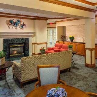 A cozy living room with a fireplace and comfortable seating.