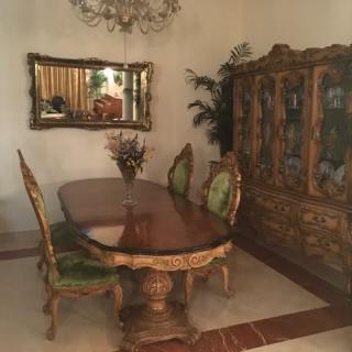 A traditional dining room with elegant furniture and decor.