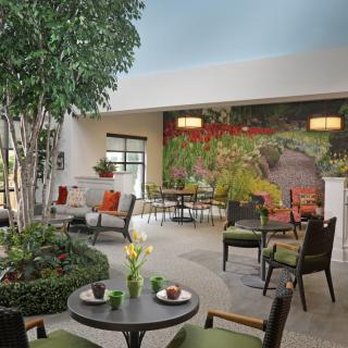 A cozy indoor seating area with lush plants and modern furnishings.