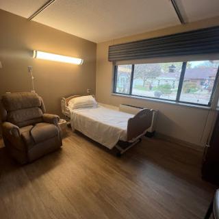 A spacious and well-lit hospital room designed for patient comfort.