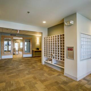 Modern apartment lobby with mailboxes and entrance area.
