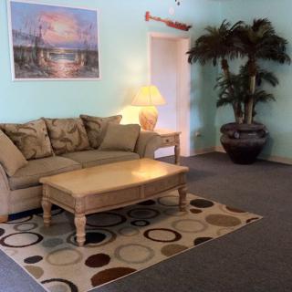 A cozy living room with a sofa, coffee table, and decorative elements.