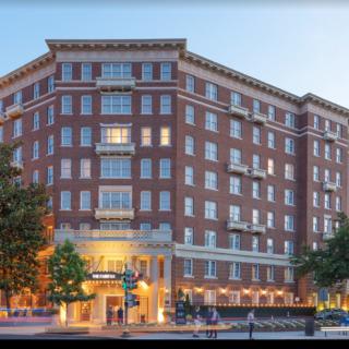 A view of a brick hotel building during the evening.