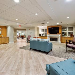 A spacious and modern living room with comfortable seating and a fireplace.