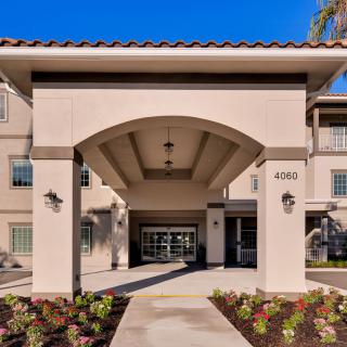 Front entrance of a residential building with decorative landscaping.