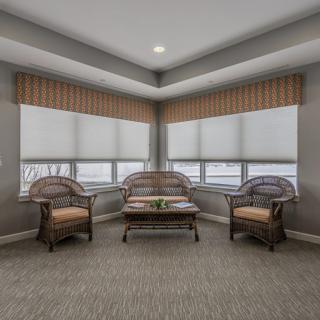 A cozy seating area featuring comfortable chairs and large windows that invite natural light into the space.
