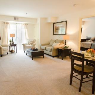 A cozy and bright living room with comfortable seating and a dining area.