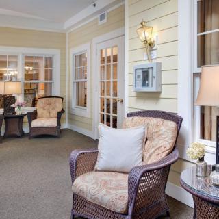 A cozy living room with wicker chairs, soft lighting, and warm decor.
