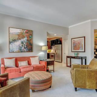 A cozy living room with colorful furniture and decorative artwork.