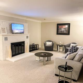 A cozy living room with a fireplace and modern decor.