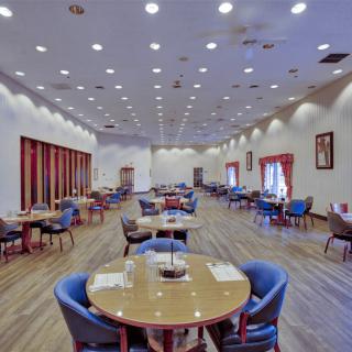 Spacious restaurant dining area with neatly arranged tables and chairs.
