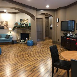 A cozy living room with hardwood floors, stylish furniture, and a warm fireplace.