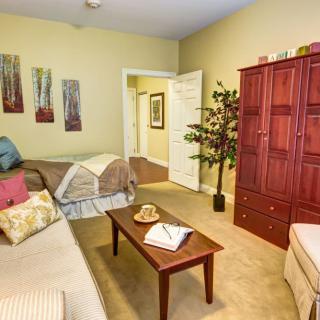 A cozy living area with a sofa, bed, and coffee table.