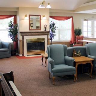 A cozy living room with a fireplace, comfortable seating, and a warm, inviting atmosphere.