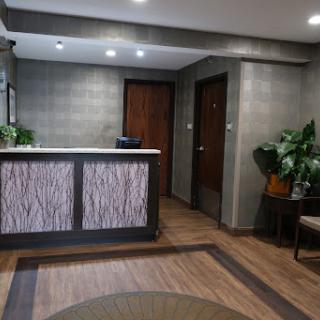 A modern reception area featuring a sleek front desk and comfortable seating.