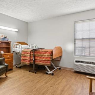 A hospital room featuring a patient bed and medical equipment.