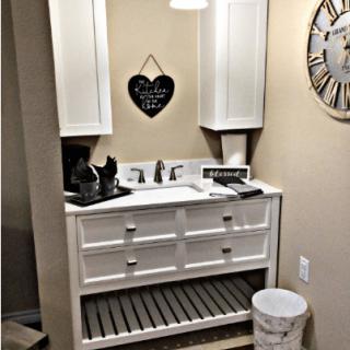 A well-organized bathroom with a white vanity and decorative elements.