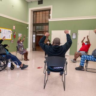 Seniors participating in a group exercise session, promoting wellness and community engagement.