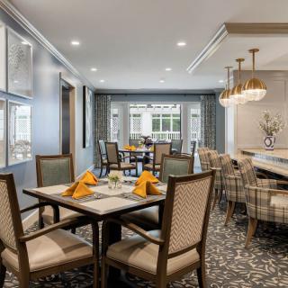 A modern dining room with elegant furnishings and a well-arranged table setting.