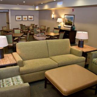 A cozy lounge area featuring comfortable seating and warm lighting, perfect for relaxation.